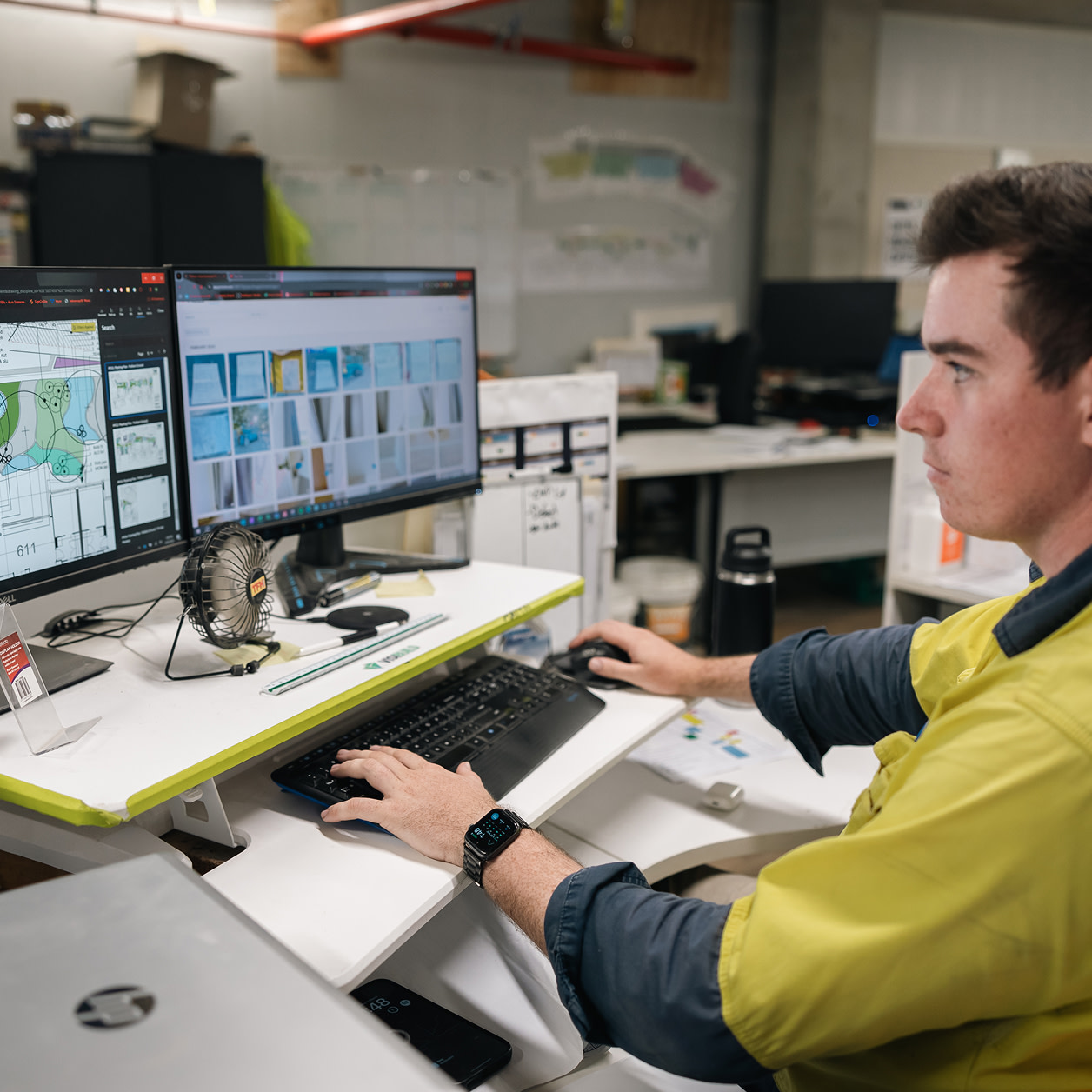 A construction worker using a tablet at a construction site