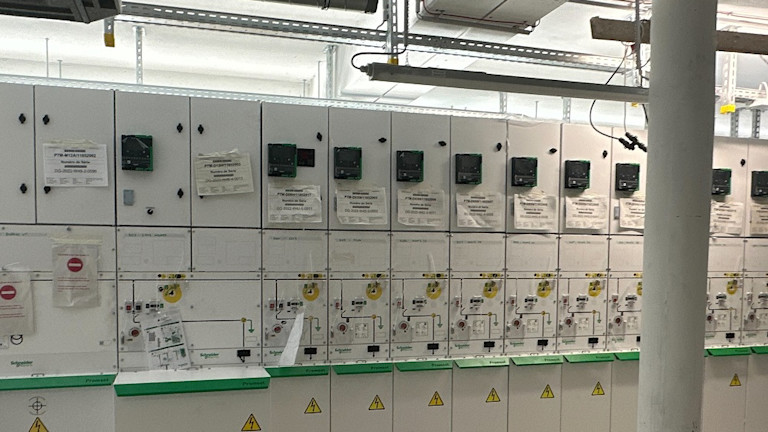 An electrical room with white cabinets