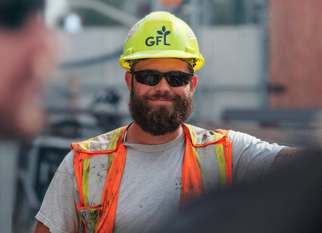 A construction worker using a tablet on site