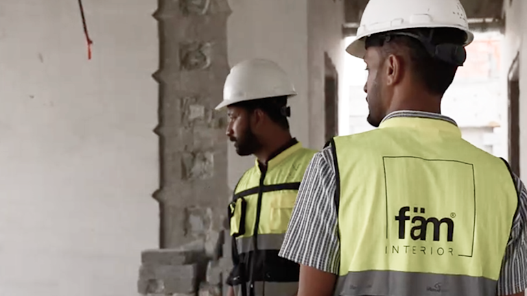 Two fam interiors workers at a construction site